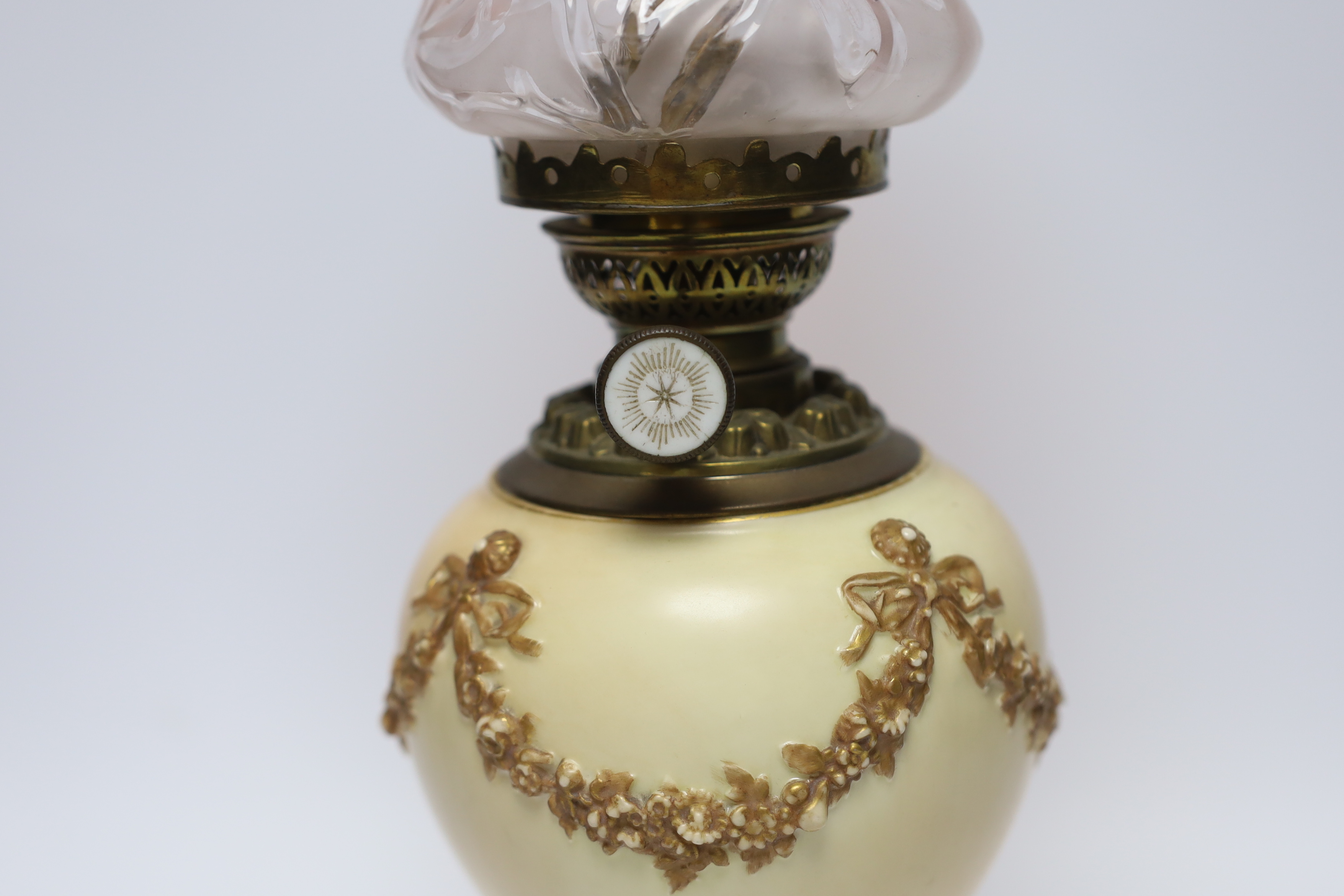 A Royal Worcester blush ivory oil lamp with fluted glass shade, 46cm high